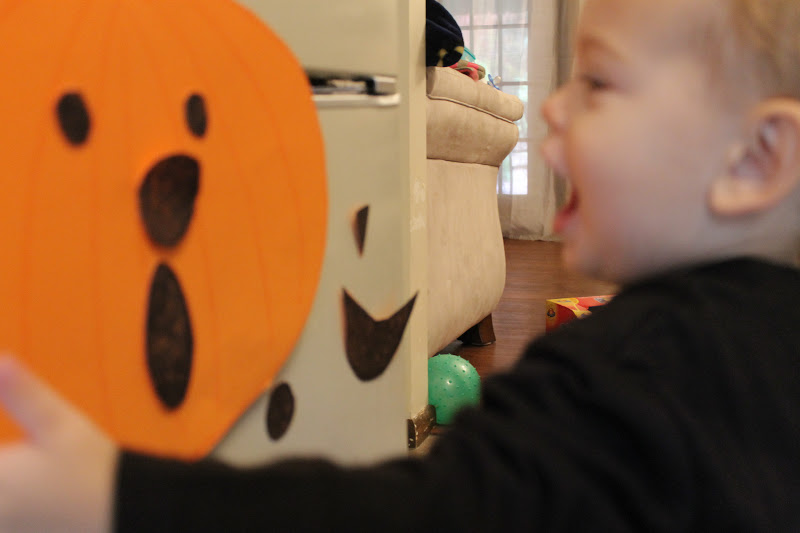 Toddler copying a surprised pumpkin face