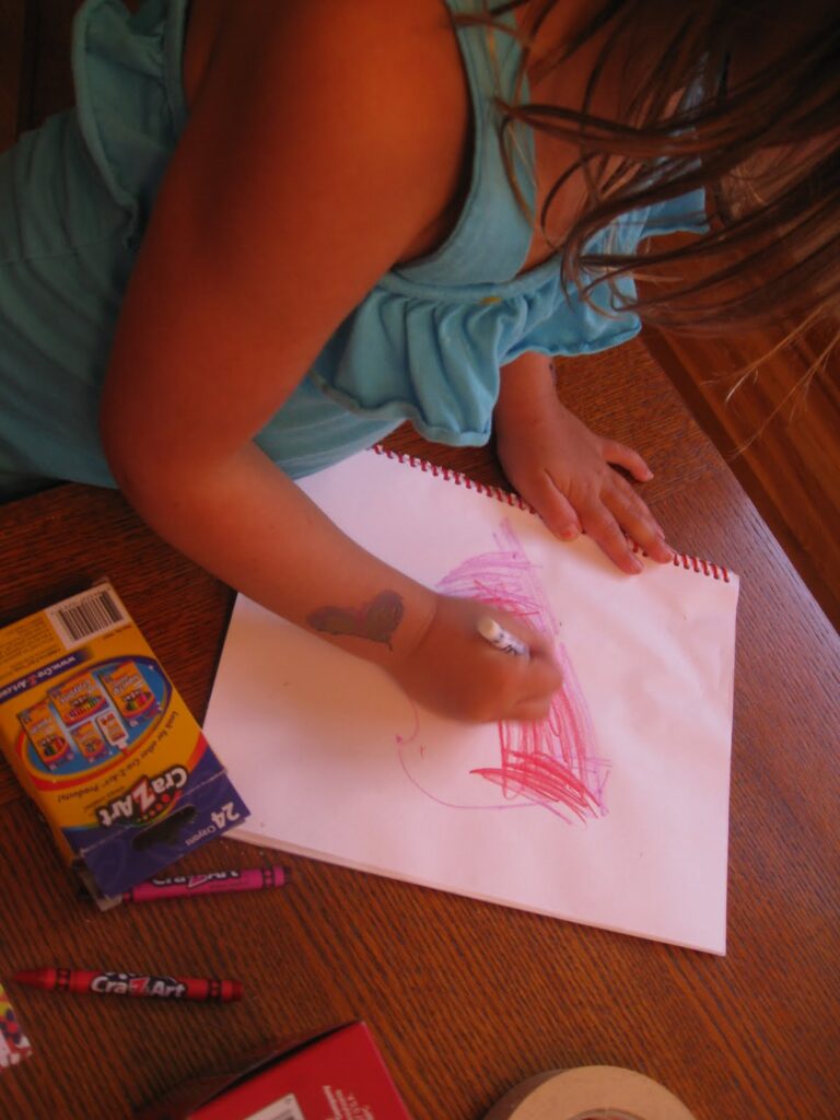 Child drawing on a notebook
