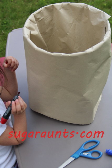 craft paper wrapped and taped around five gallon bucket