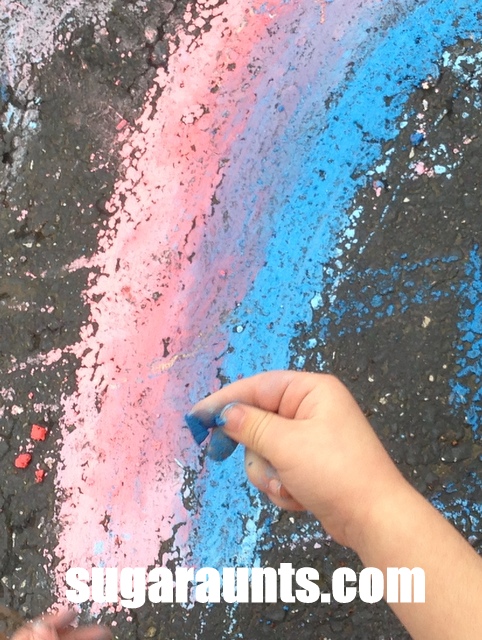 Play with wet chalk to make a driveway rainbow