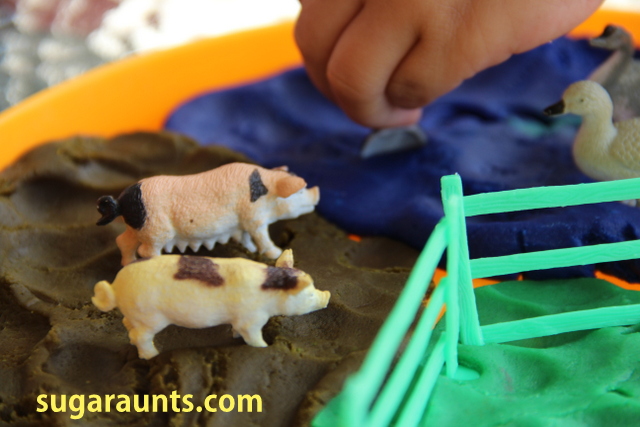 Farm play dough small world with miniature pigs in brown play dough