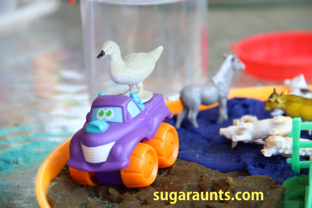 Goose toy on a farm tractor in a play dough small world farm activity
