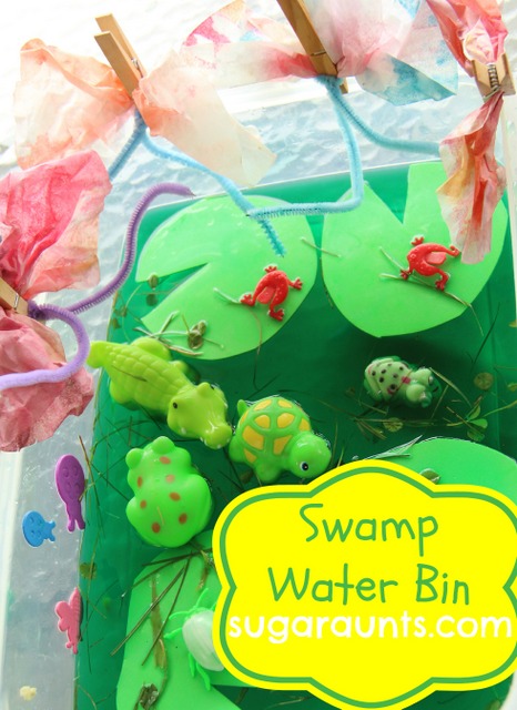 sensory bin with a swamp theme, includes lily pads, toy frogs and water toys