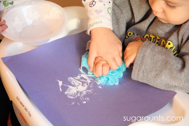 Toddlers can paint with a shower puff for fine motor and sensory crafts.