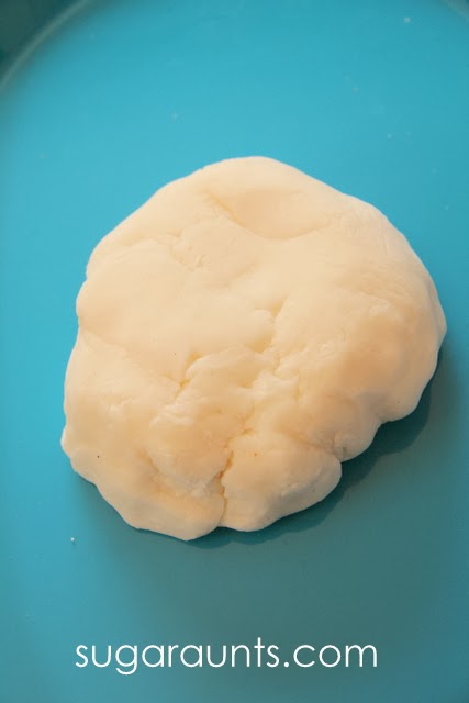 lump of baking soda dough on a blue plate