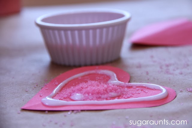 Bath salts sprinkled on glue for a heart craft for kids