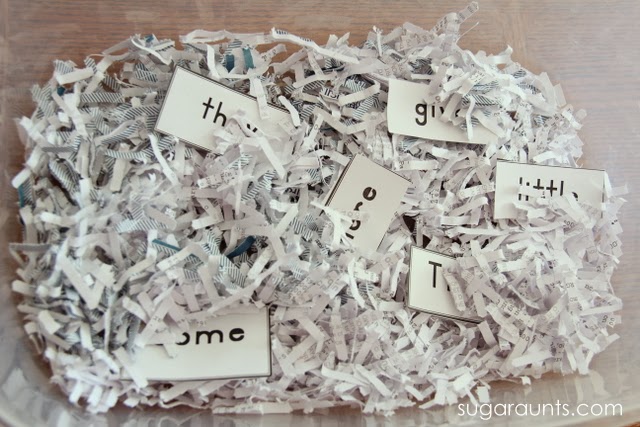 Kindergarten sight words in a sensory bin with shredded paper.