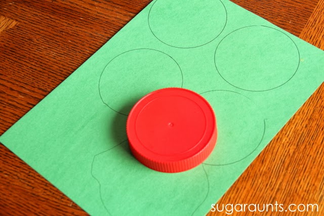 Trace a lid to make circles for cherry blossom tree craft.