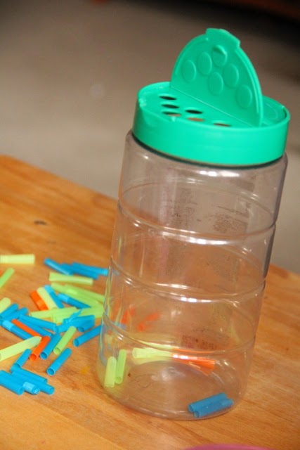 These grated cheese containers are awesome for fine motor play with small objects!