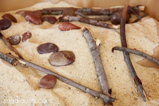 Easy sensory bin with sticks, stones, and sand
