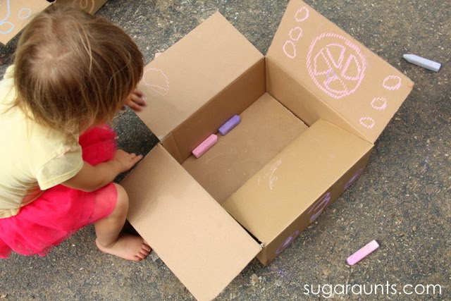Outside play with a cardboard box.