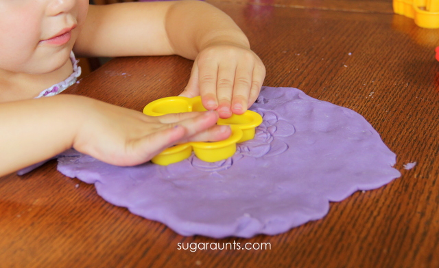 Child playing with DIY play dough made from purple crayons