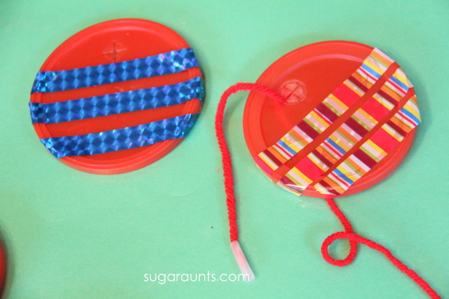 Use plastic lids and washi tape to make a fine motor garland