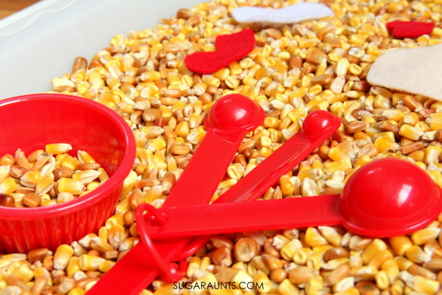 Corn sensory bin for scooping and pouring fine motor play