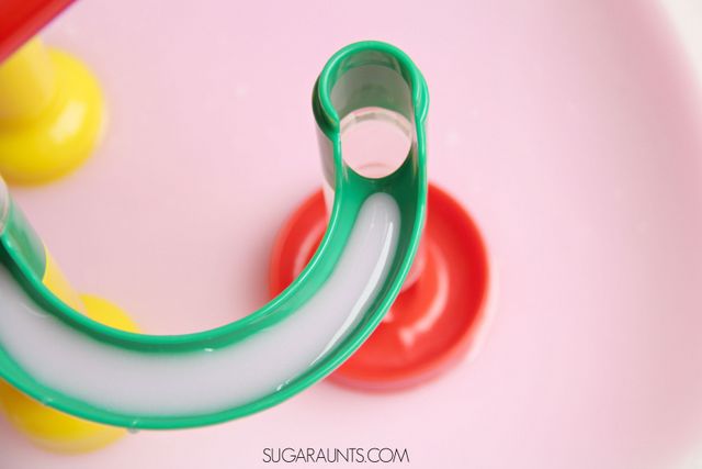 Ooobleck recipe and sensory play with a marble run! This is awesome sensory play and creative fine motor work when kids scoop and pour the oobleck into the marble run.  Watching the oobleck slowly run down the marble run is so mesmerizing and calming!