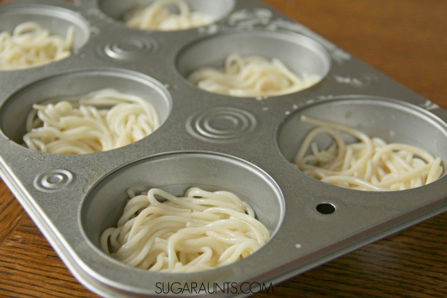 Spaghetti Cups Recipe Cooking with Kids recipe that kids will love! Load these spaghetti cups with vegetables for a creative snack, appetizer, or main dish that uses leftover pasta or cooked spaghetti.  This is a unique and fresh muffin tin recipe for families that can be filled with your kids' tastes!