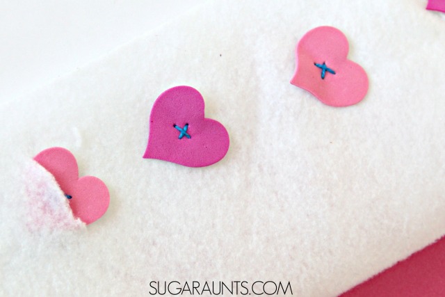 Teach kids how to button with this easy DIY buttoning teaching tool for fine motor practice and play, with hearts. Perfect for Valentine's Day