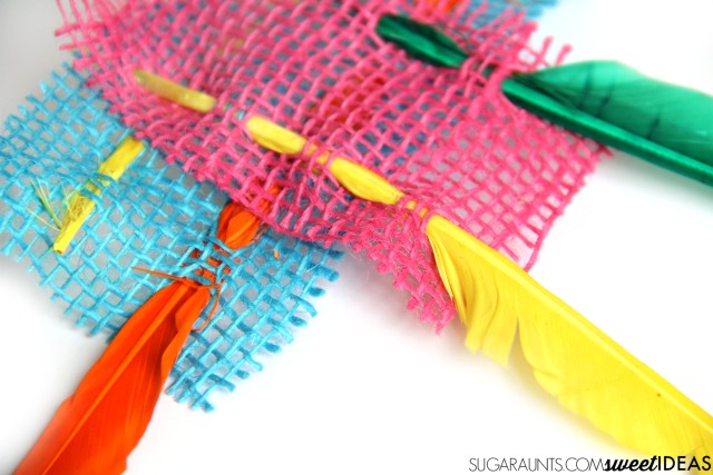 Weaving colorful feathers and colored burlap fine motor activity
