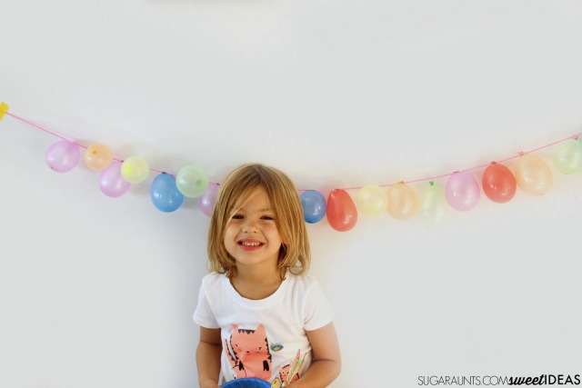 Balloon garland for parties- This would be perfect for kids' birthday parties as a photo backdrop, tablescape feature, or strung across the room.