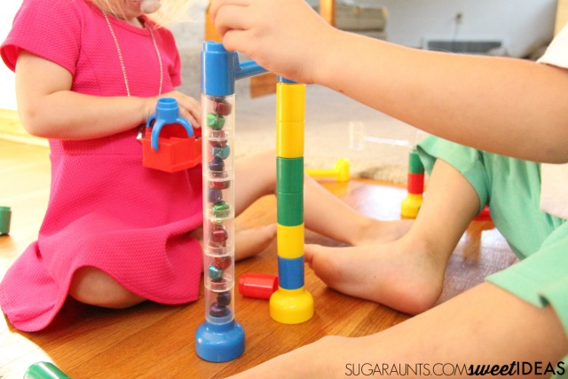 Need Christmas activities for preschoolers? Combine a marble run with jingle bells to promote fine motor skills and visual processing skills with a Christmas theme.